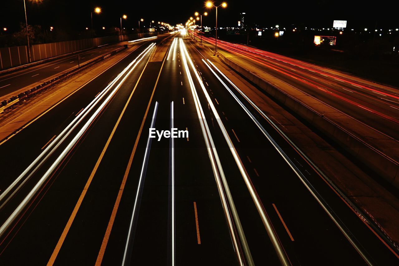 High angle view of light trails on road at night