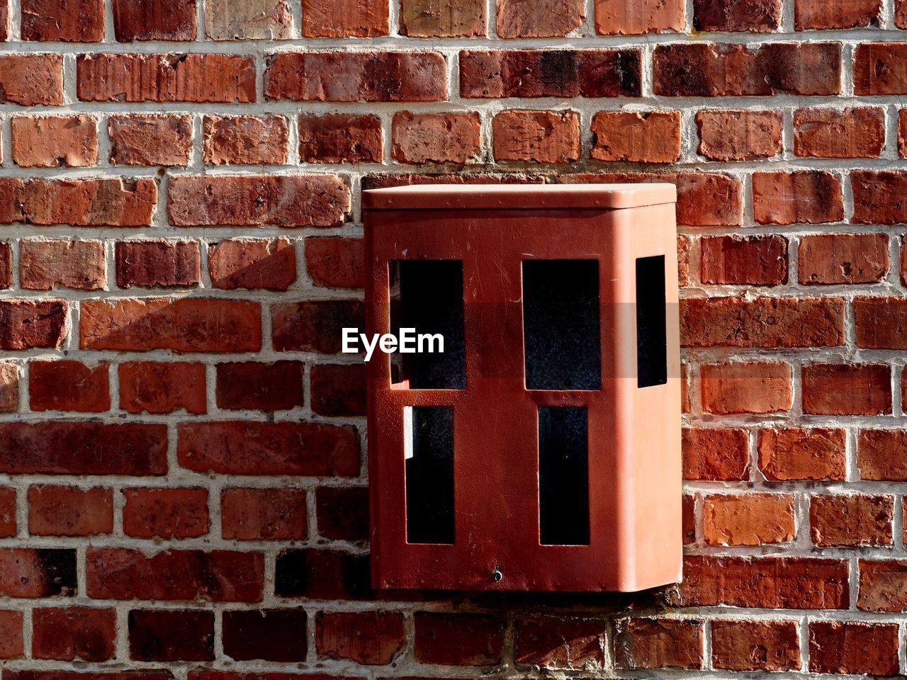 RED WINDOW ON BRICK WALL WITH WINDOWS