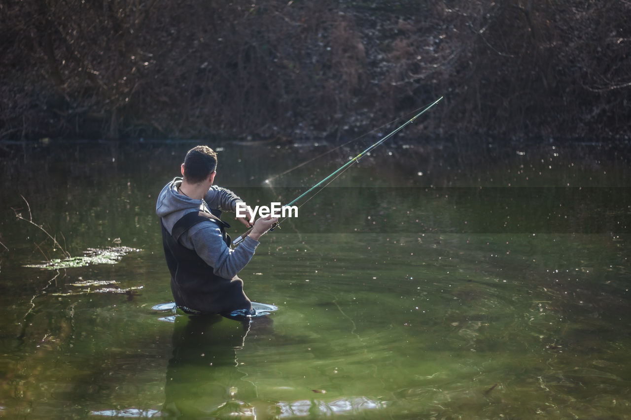 Man fishing in lake