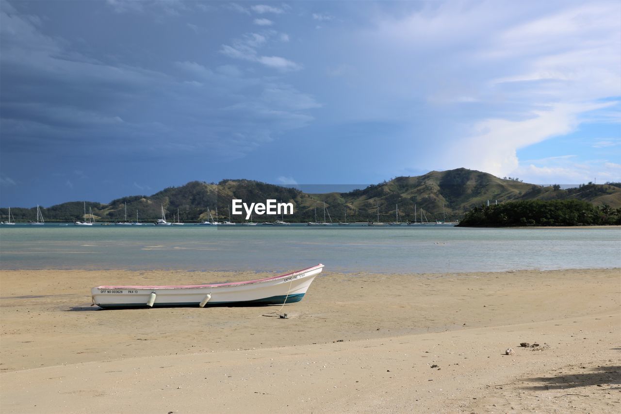 Boat on beach against sky