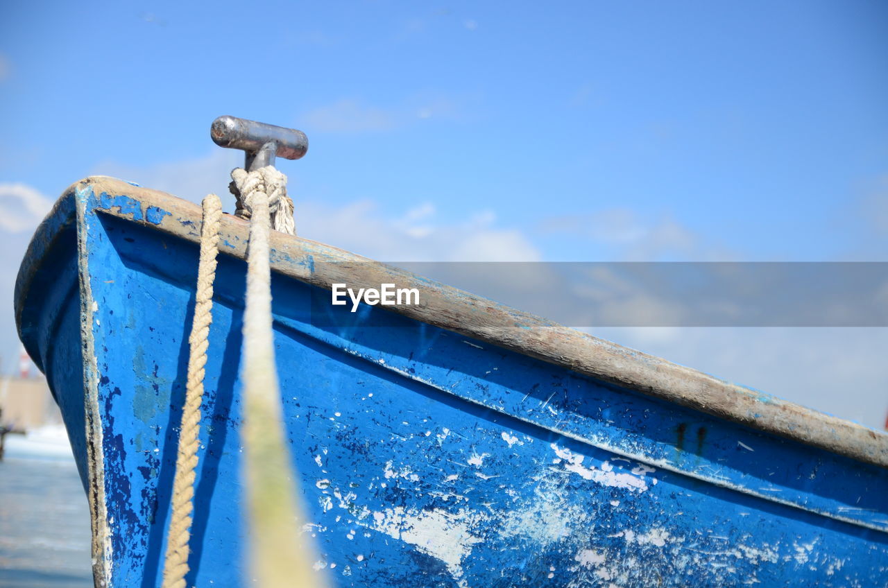 Close-up of boat against blue sky