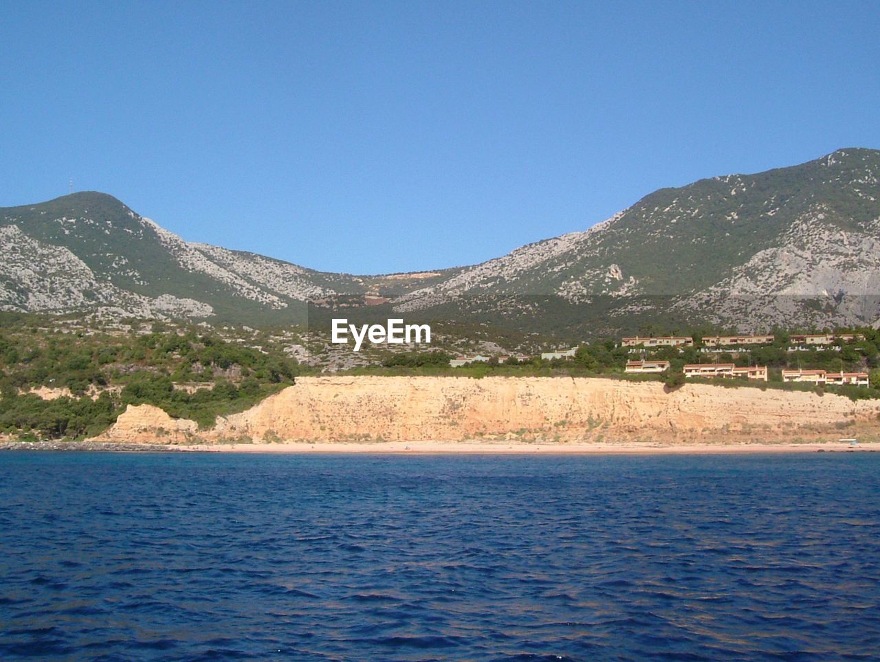 Scenic view of lake against clear blue sky