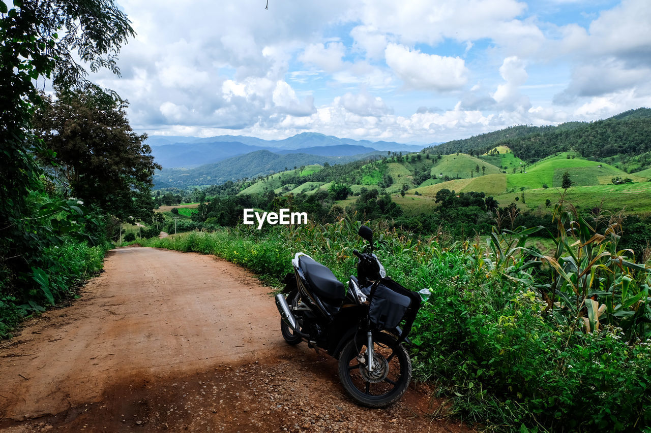 MOTORCYCLE ON ROAD AGAINST SKY