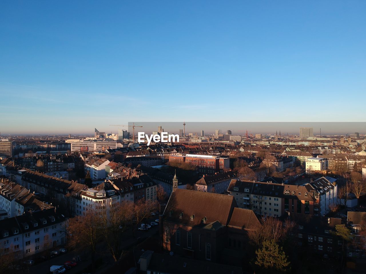 HIGH ANGLE VIEW OF BUILDINGS AGAINST CLEAR BLUE SKY