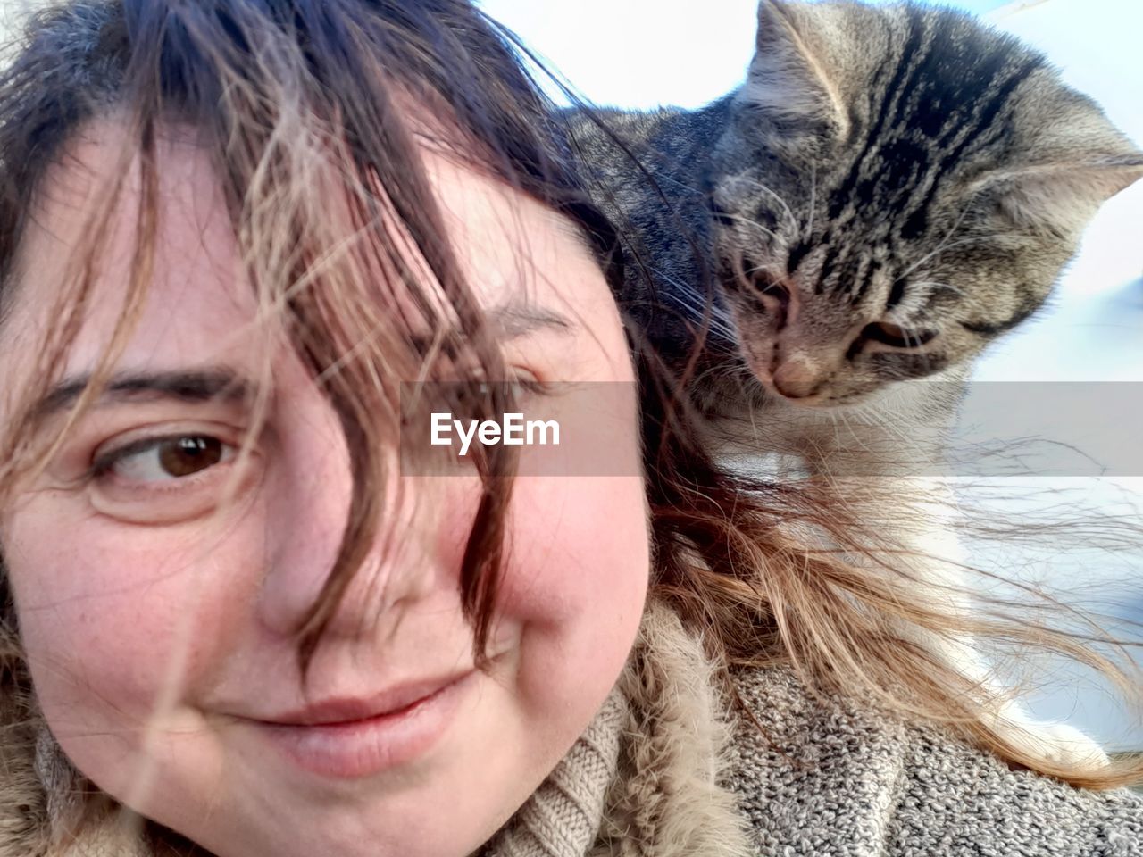 CLOSE-UP PORTRAIT OF CAT WITH WOMAN