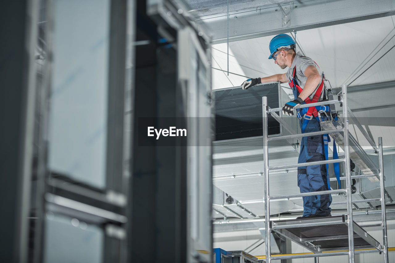 Low angle view of man working in factory