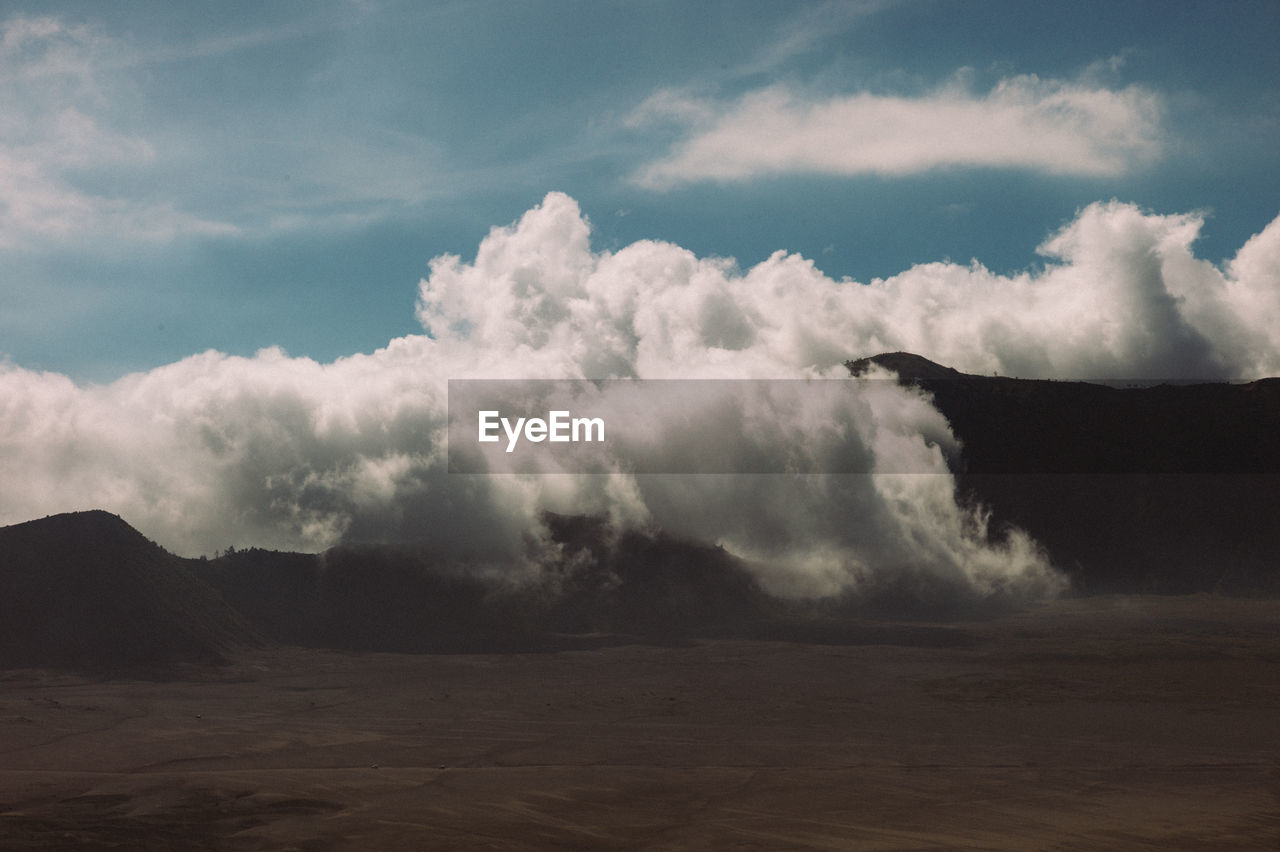 Scenic view of clouds over landscape against sky