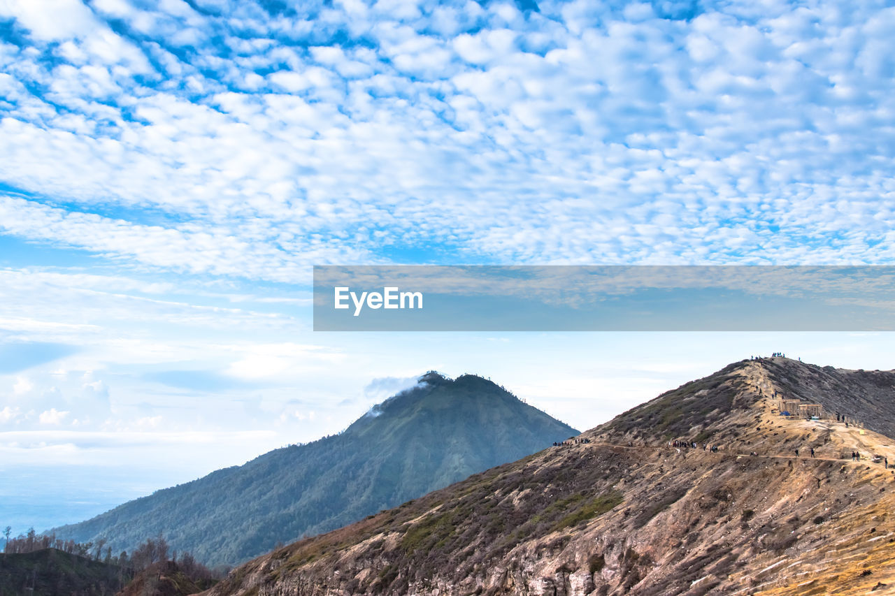 SCENIC VIEW OF MOUNTAIN AGAINST CLOUDY SKY