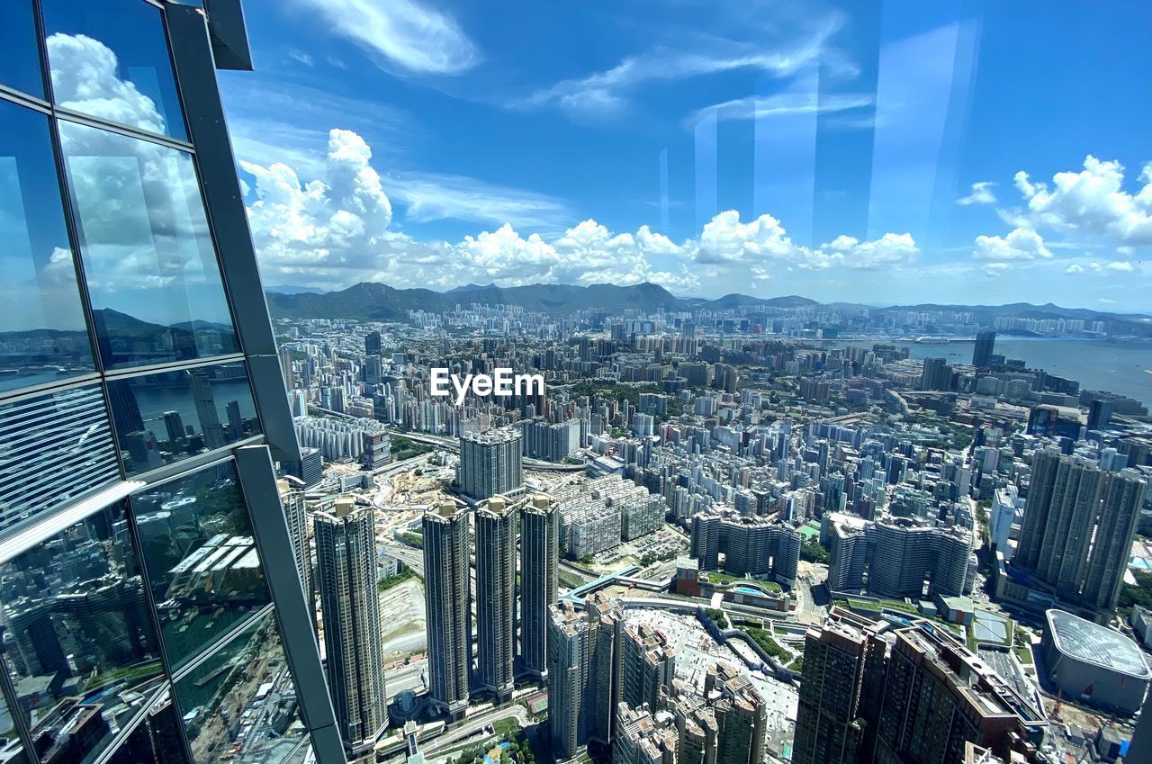 HIGH ANGLE VIEW OF MODERN BUILDINGS AGAINST SKY