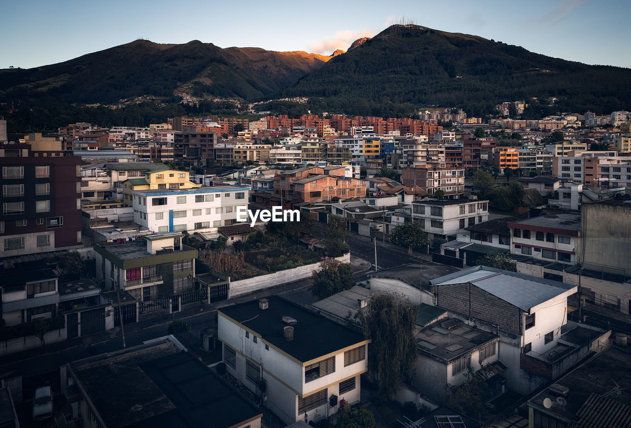 High angle view of houses in town against sky