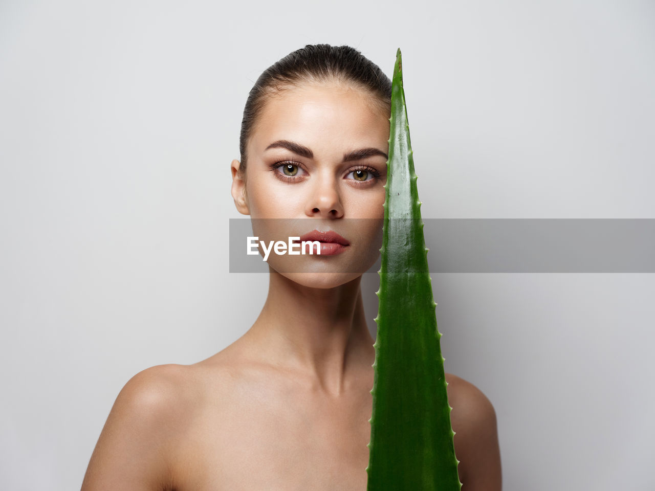 Portrait of beautiful young woman over white background