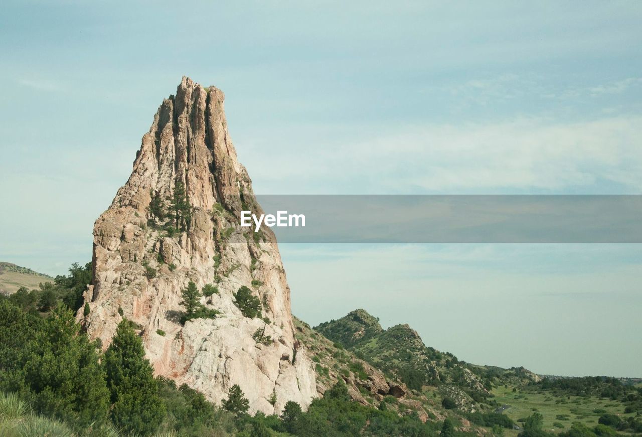 Low angle view of cliff against sky