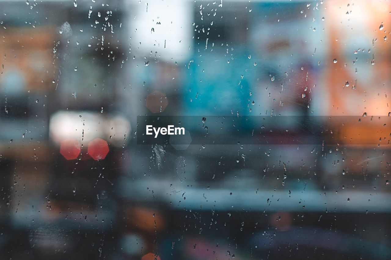 Full frame shot of wet glass window in rainy season