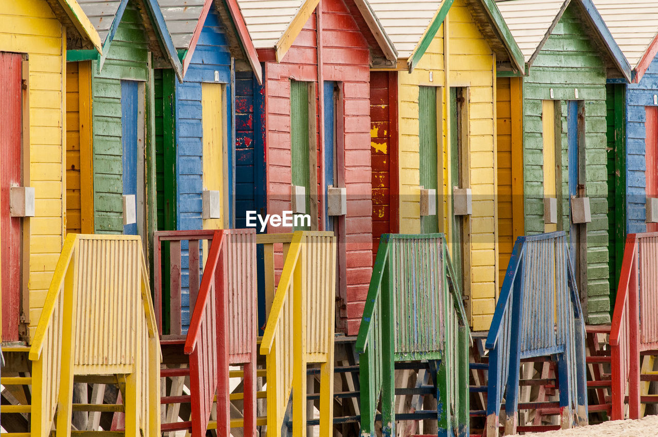 Colorful beach huts arranged in row