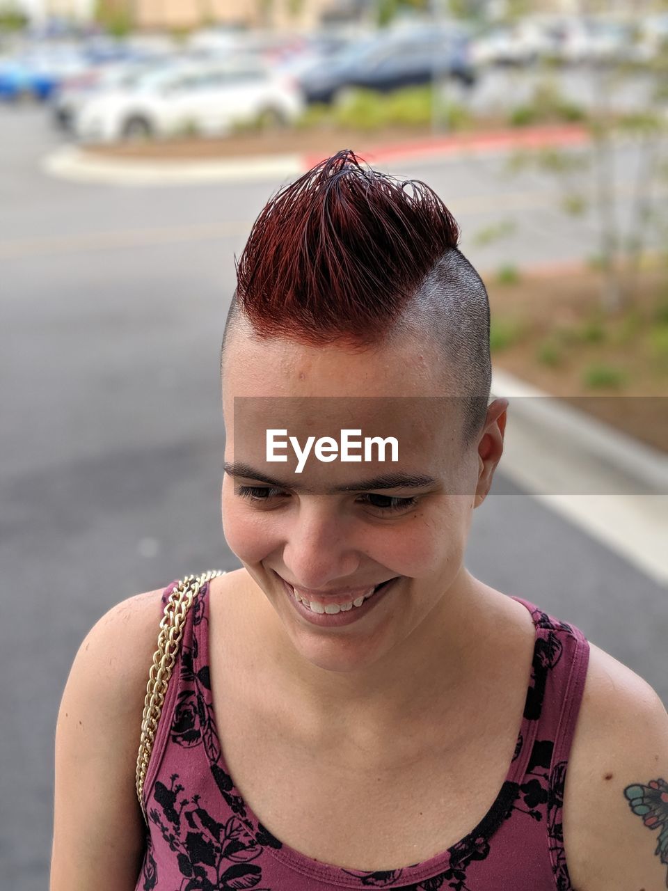 Close-up of smiling young woman looking away