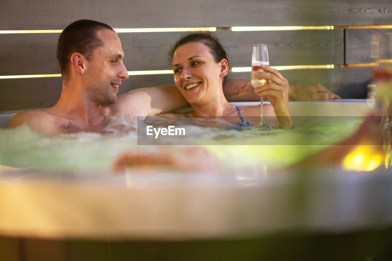 Couple bathing in hot tub