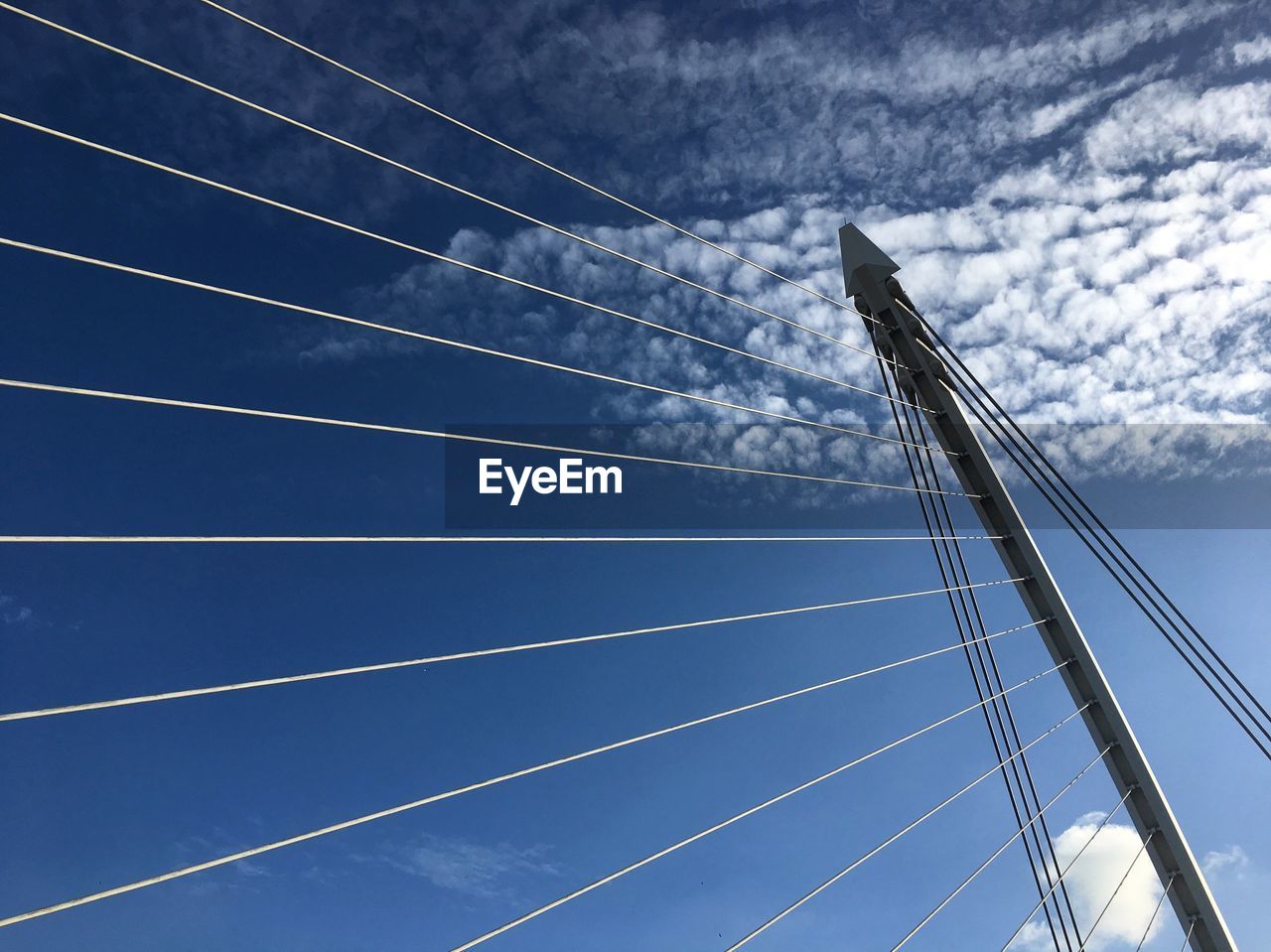 Low angle view of samuel beckett bridge against blue sky