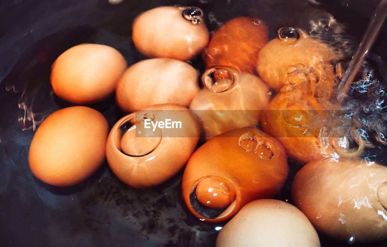 High angle view of eggs boiling in cooking pan