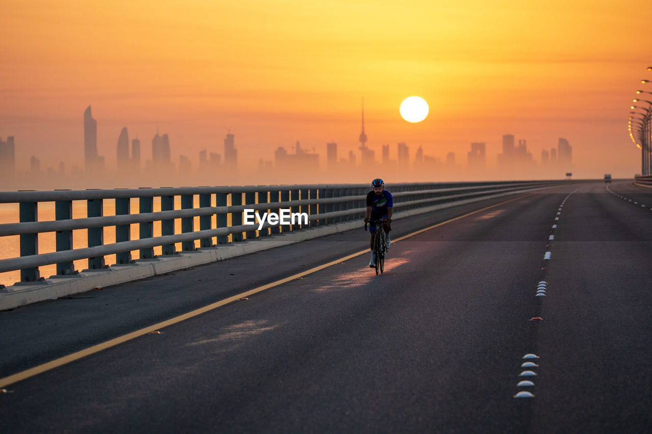 Early morning cycling with beautiful cityscape in golden hour