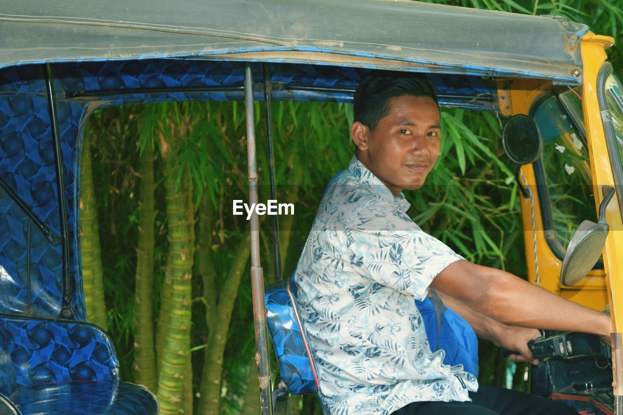 Portrait of young man driving jinrikisha