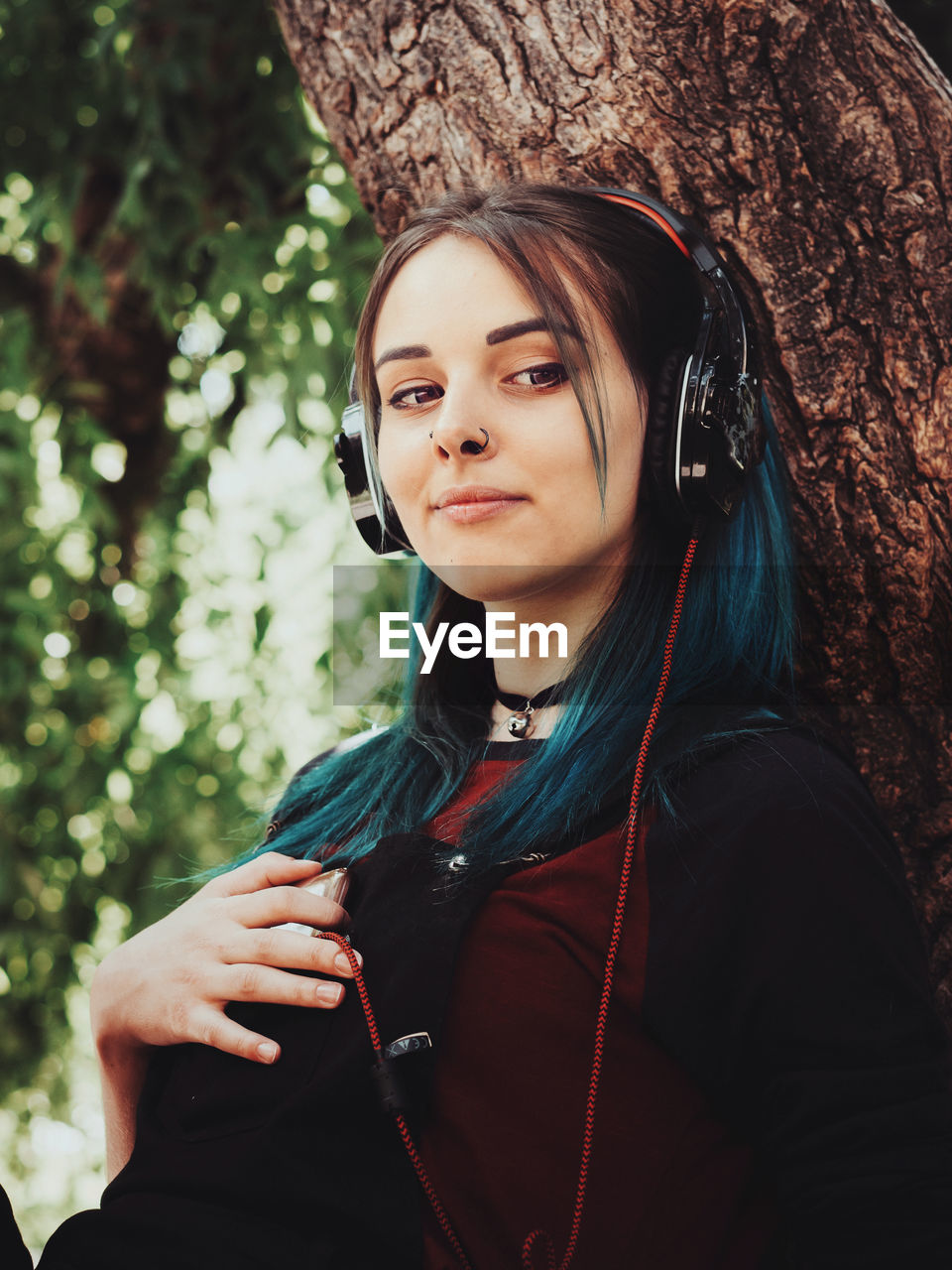 Close-up of smiling hipster listening music on headphones