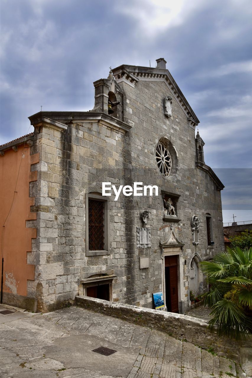 Low angle view of old church against sky