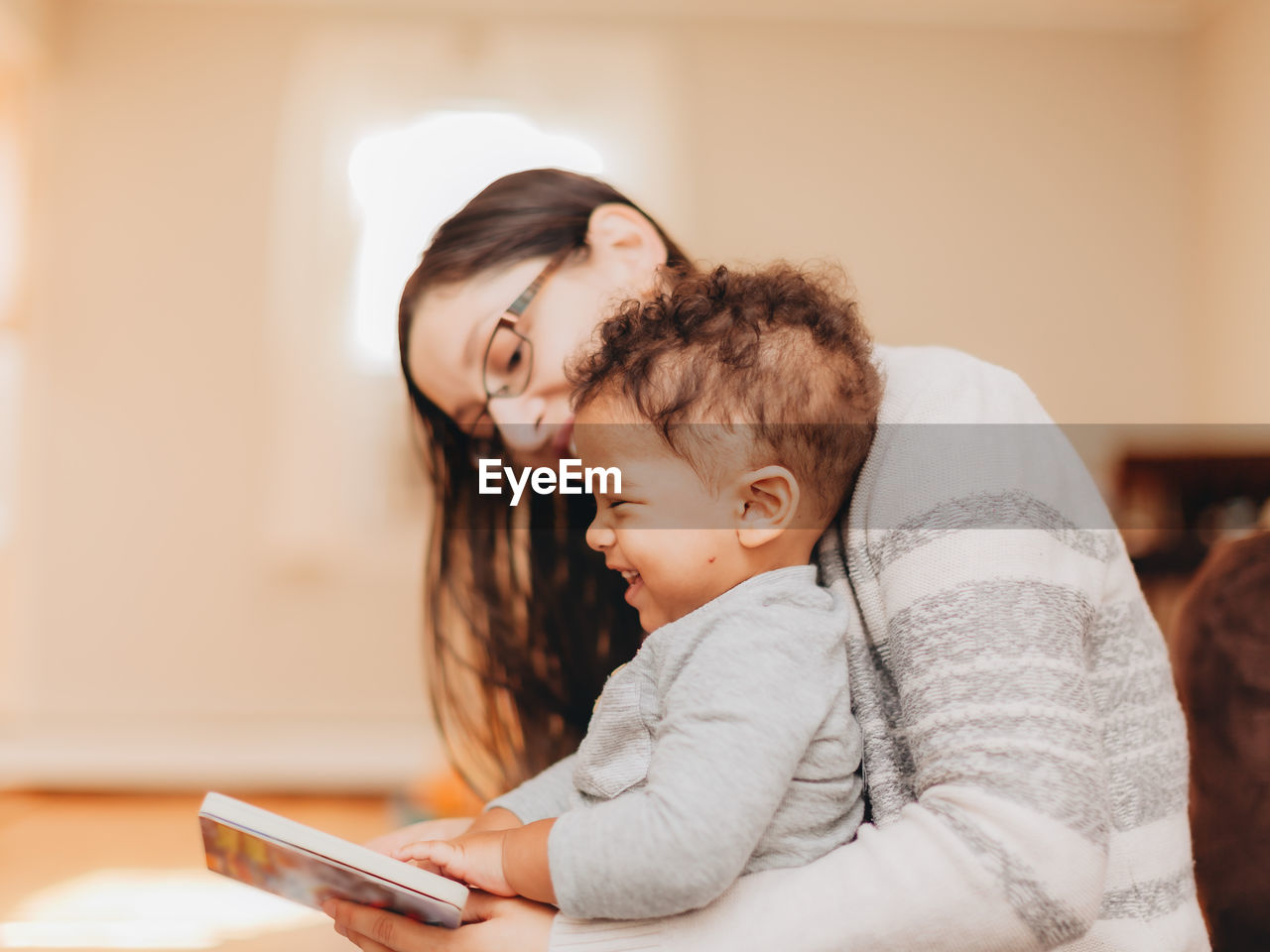 Mother and son reading book at home