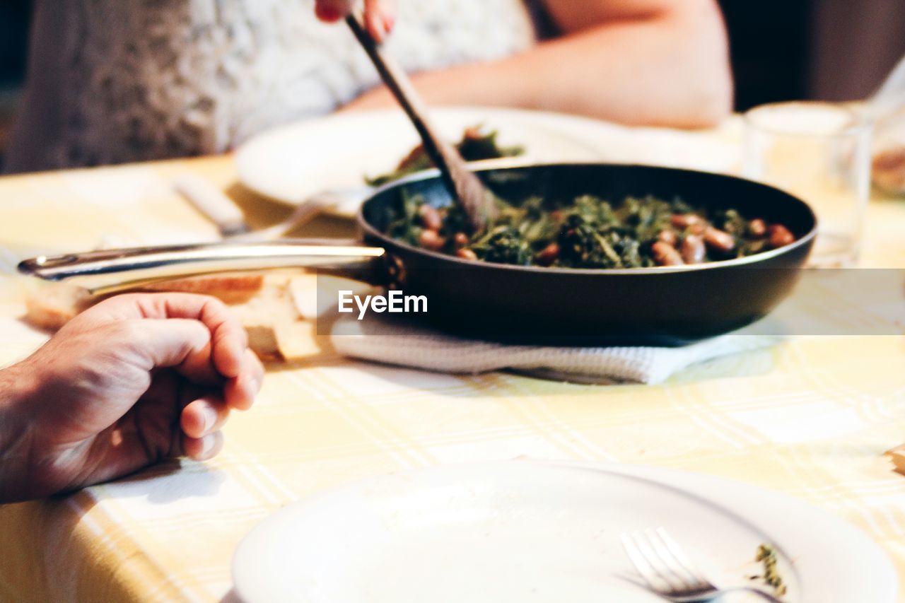 CLOSE-UP OF PERSON PREPARING FOOD