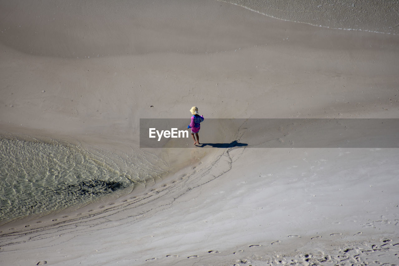 High angle view of girl walking at beach
