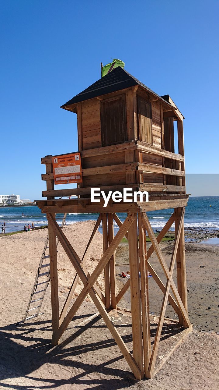 HUT ON BEACH AGAINST CLEAR BLUE SKY