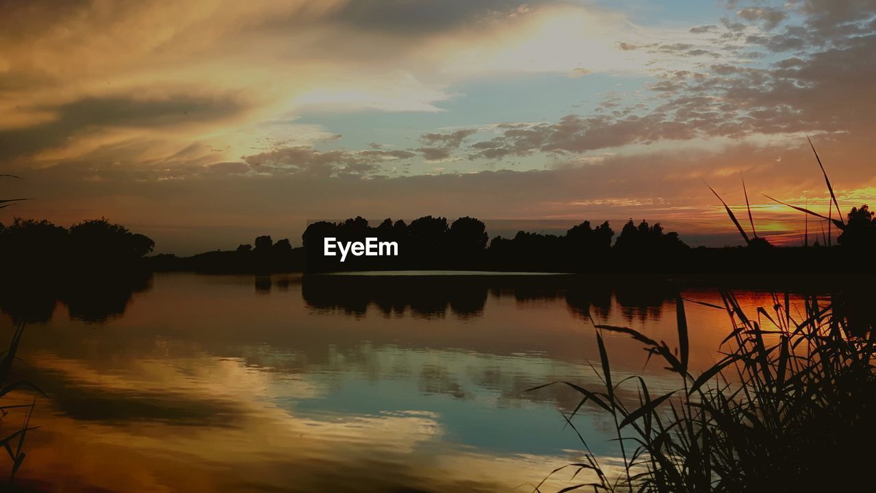 Scenic view of lake at sunset