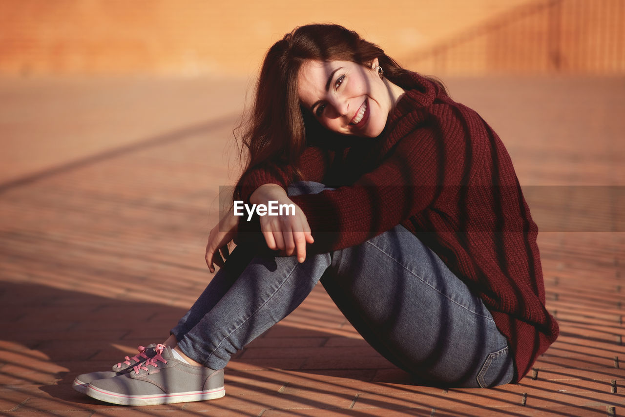 Portrait of smiling woman sitting outdoors