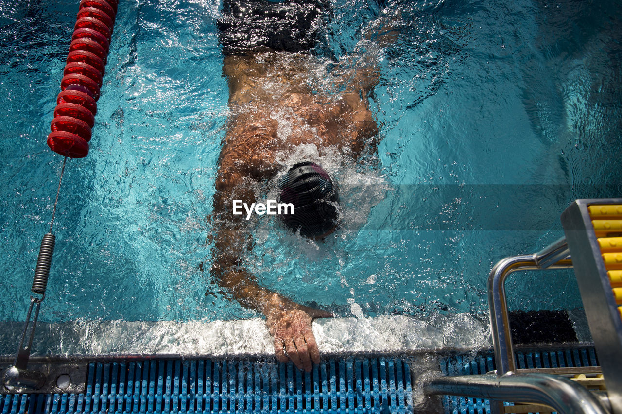 High angle view of man swimming in pool