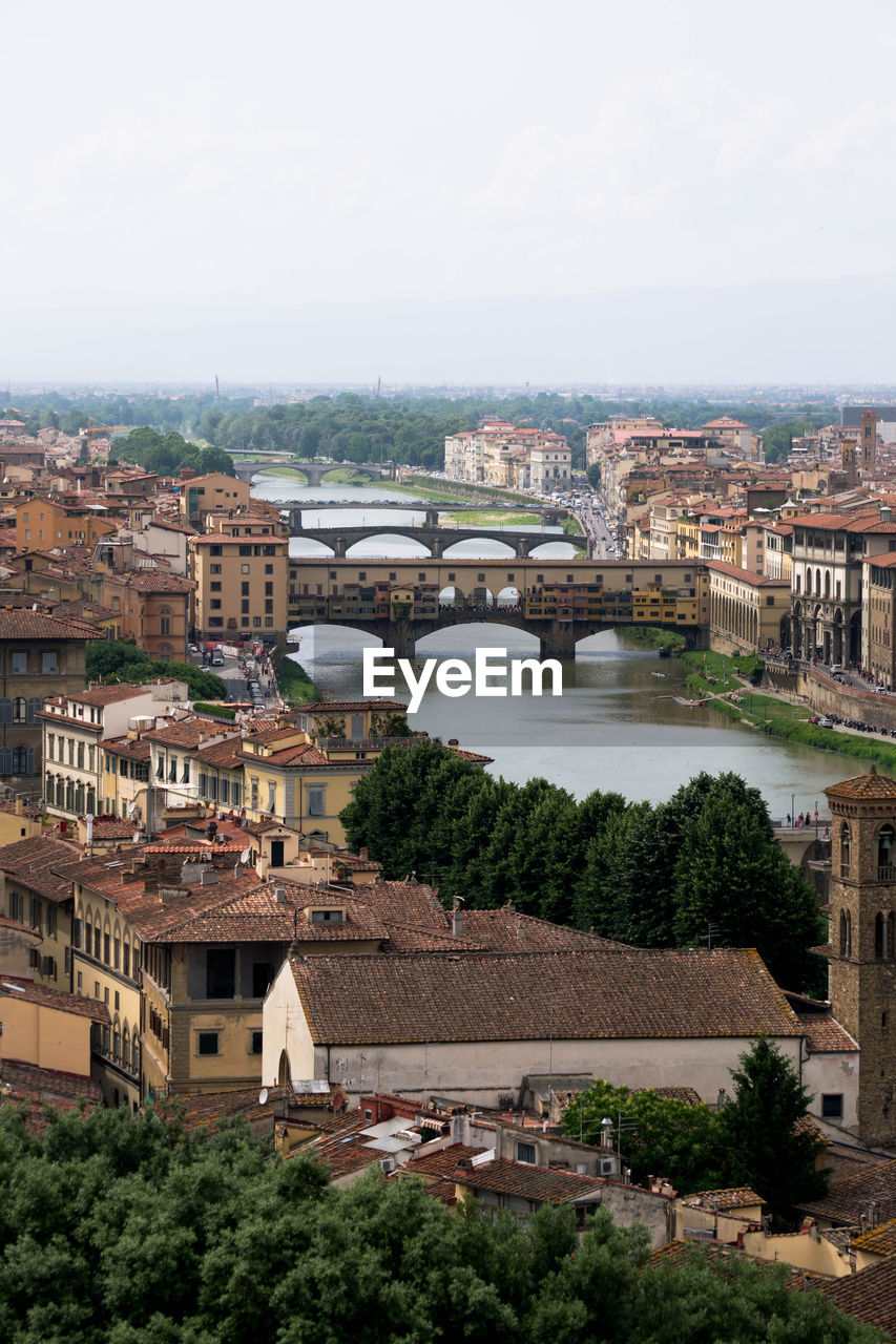 High angle view of buildings and bridge in city against sky