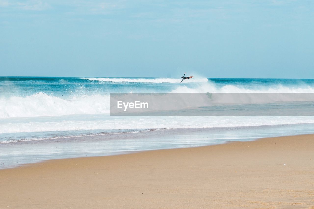 Scenic view of surfer mid-air