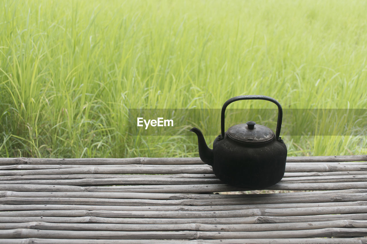 BLACK COFFEE ON FIELD BY STONE WALL
