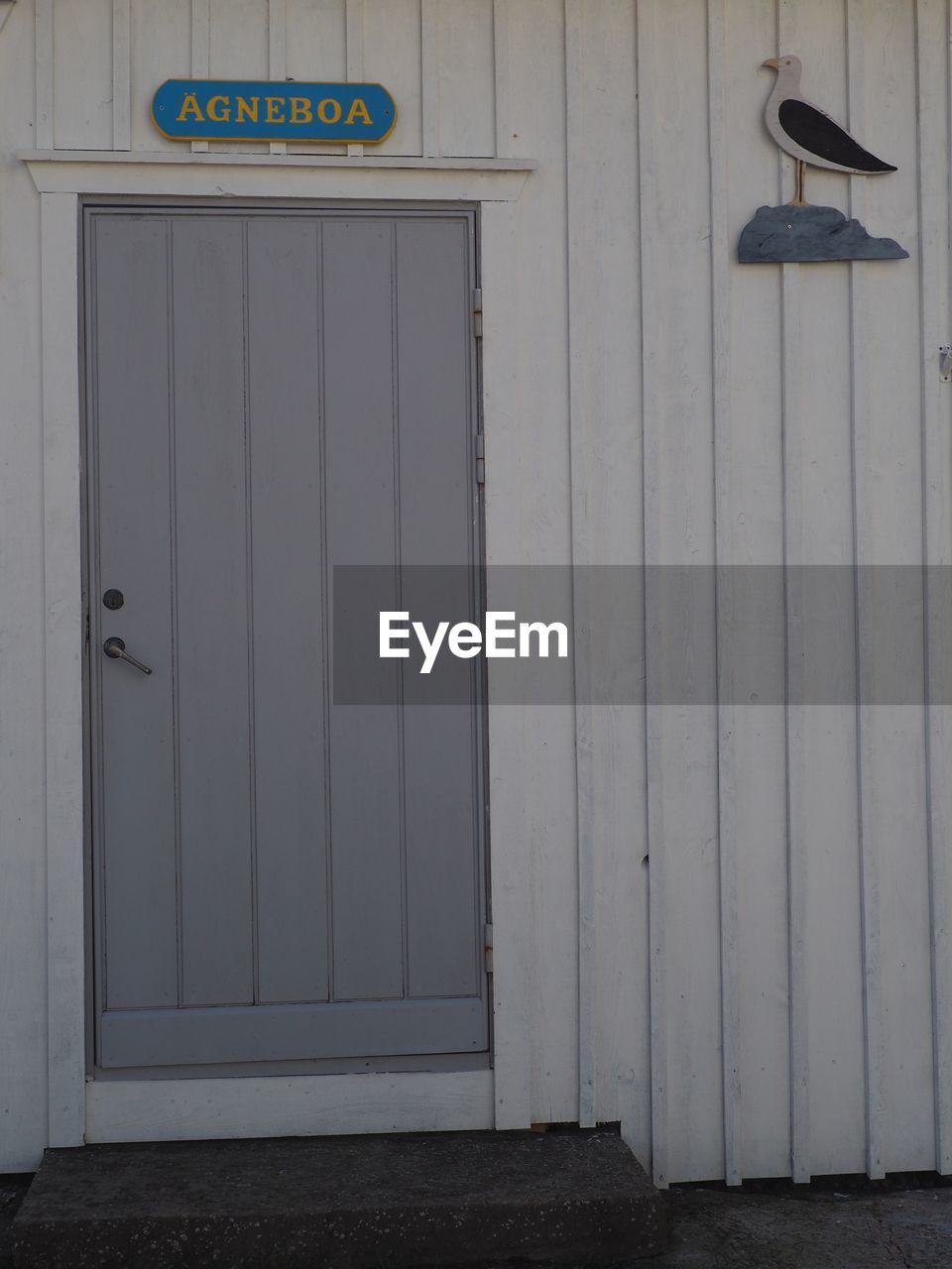 CLOSED WOODEN DOOR OF BUILDING WITH LIGHT