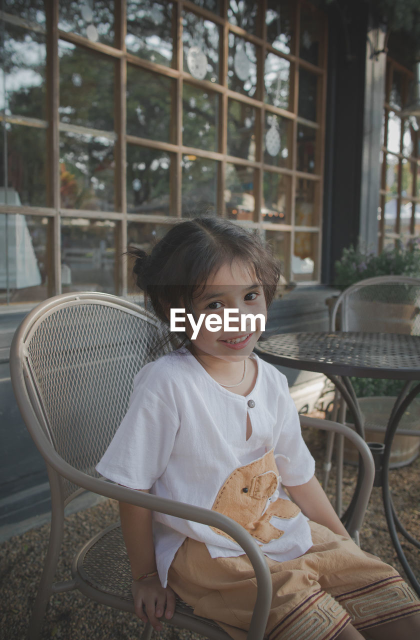 Portrait of girl sitting on seat