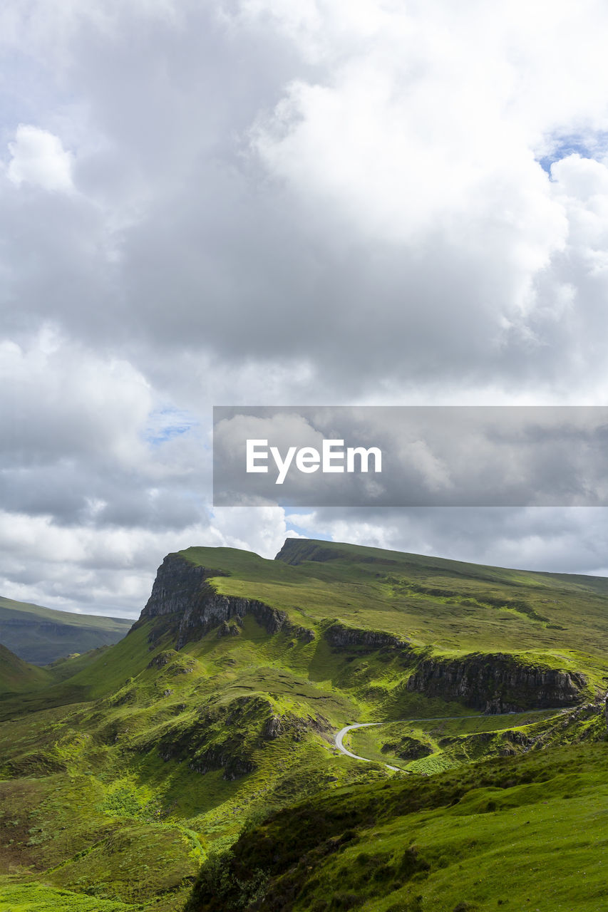 Road, cliffs, blue sky with clouds in quiraing isle of skye scotland