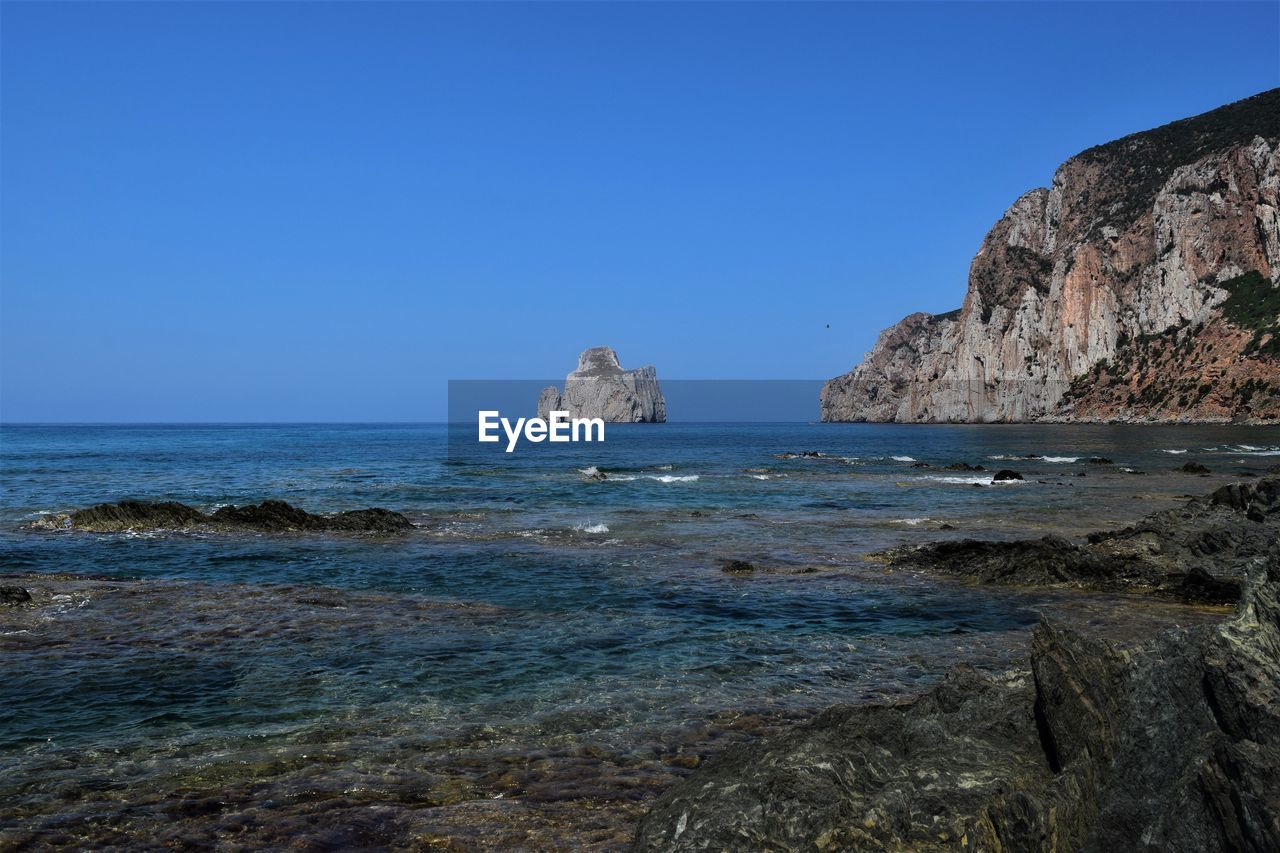 Scenic view of sea against clear blue sky