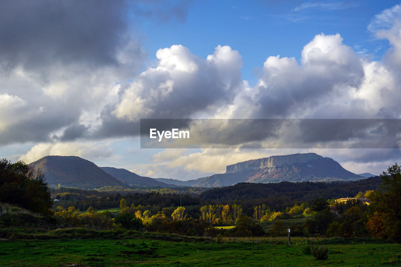 Scenic view of mountains against cloudy sky