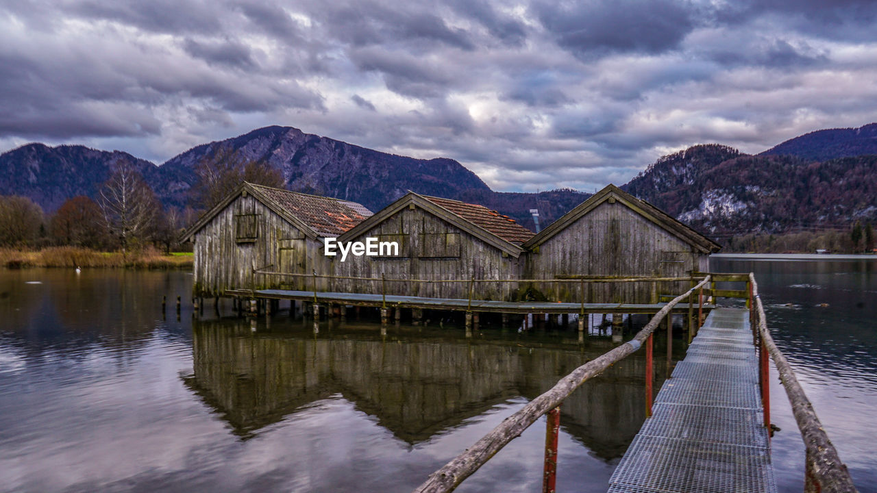 SCENIC VIEW OF LAKE BY HOUSES AGAINST SKY