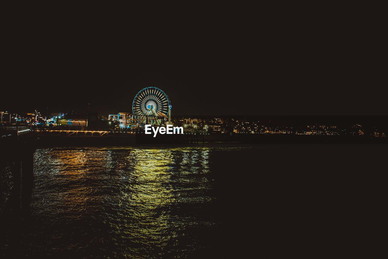 ILLUMINATED FERRIS WHEEL AT NIGHT