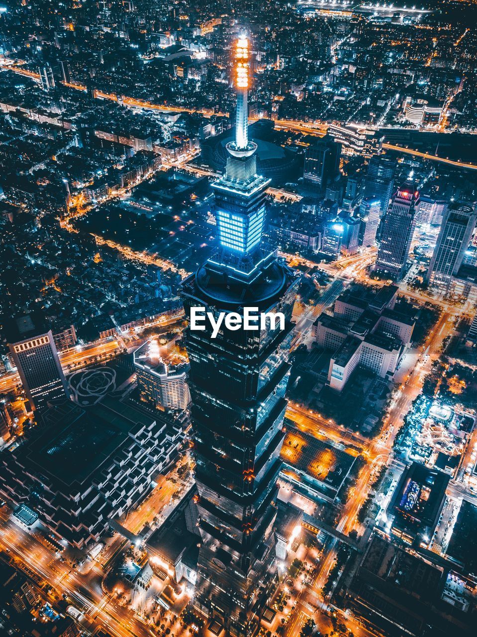 HIGH ANGLE VIEW OF ILLUMINATED CITY AT NIGHT