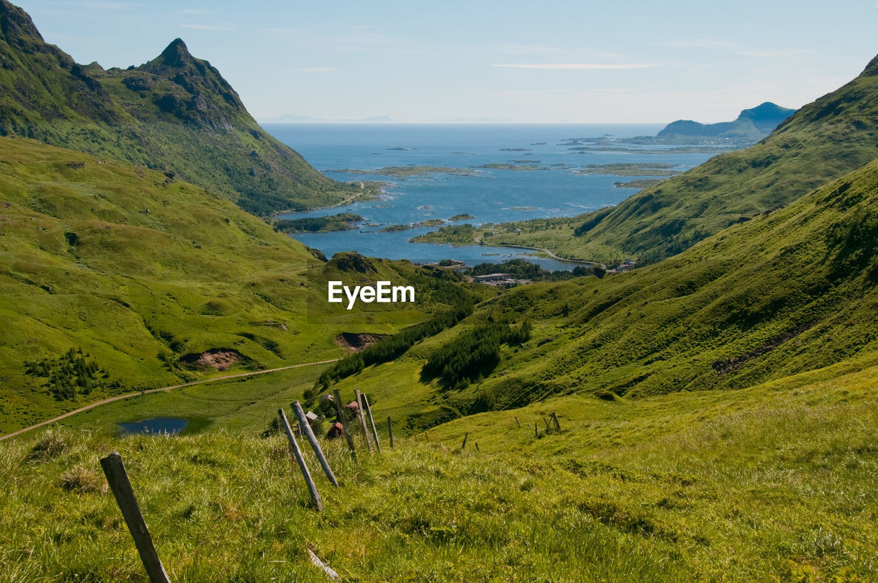 Scenic view of sea and mountains against sky