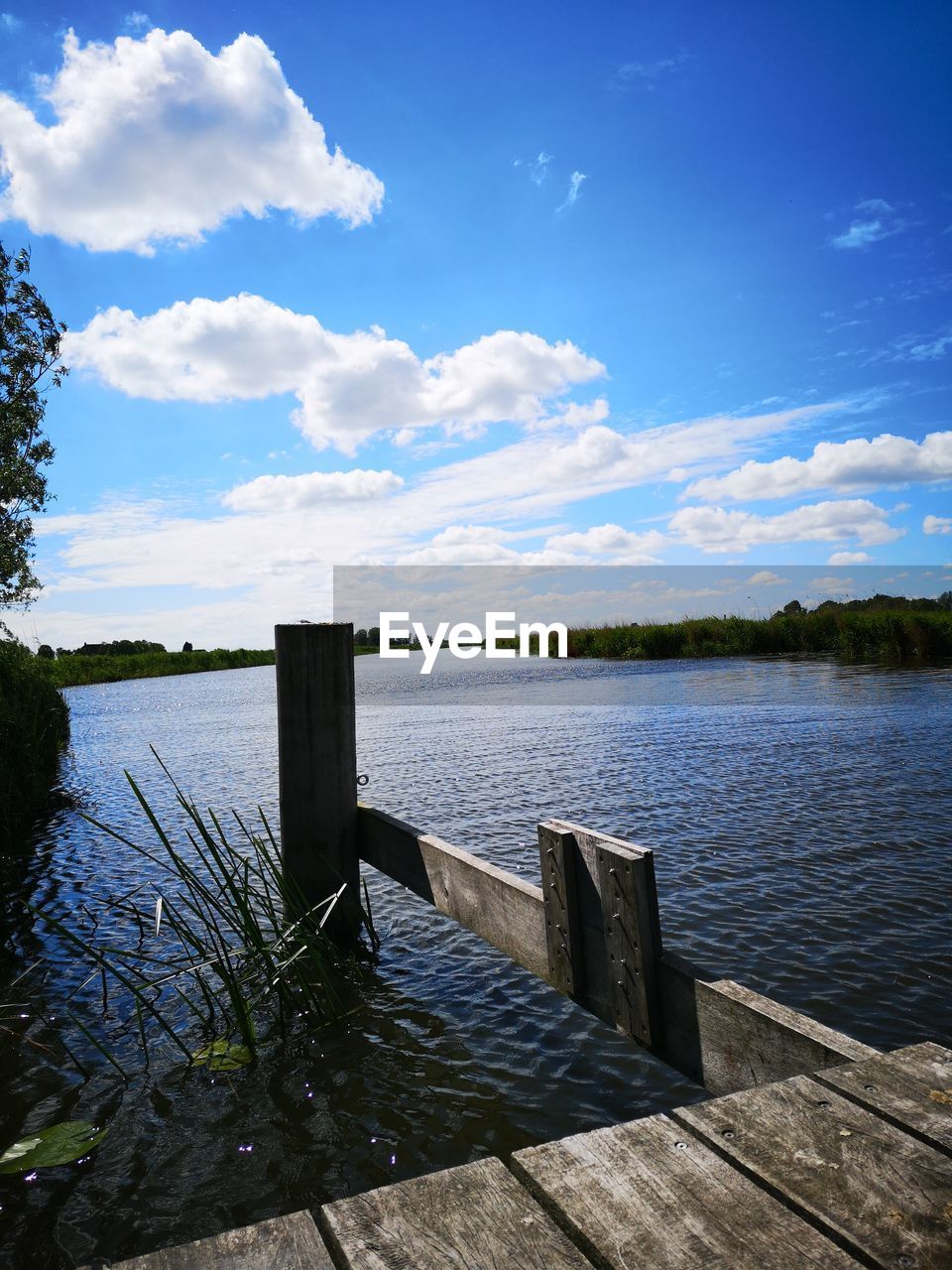 PIER ON LAKE AGAINST SKY