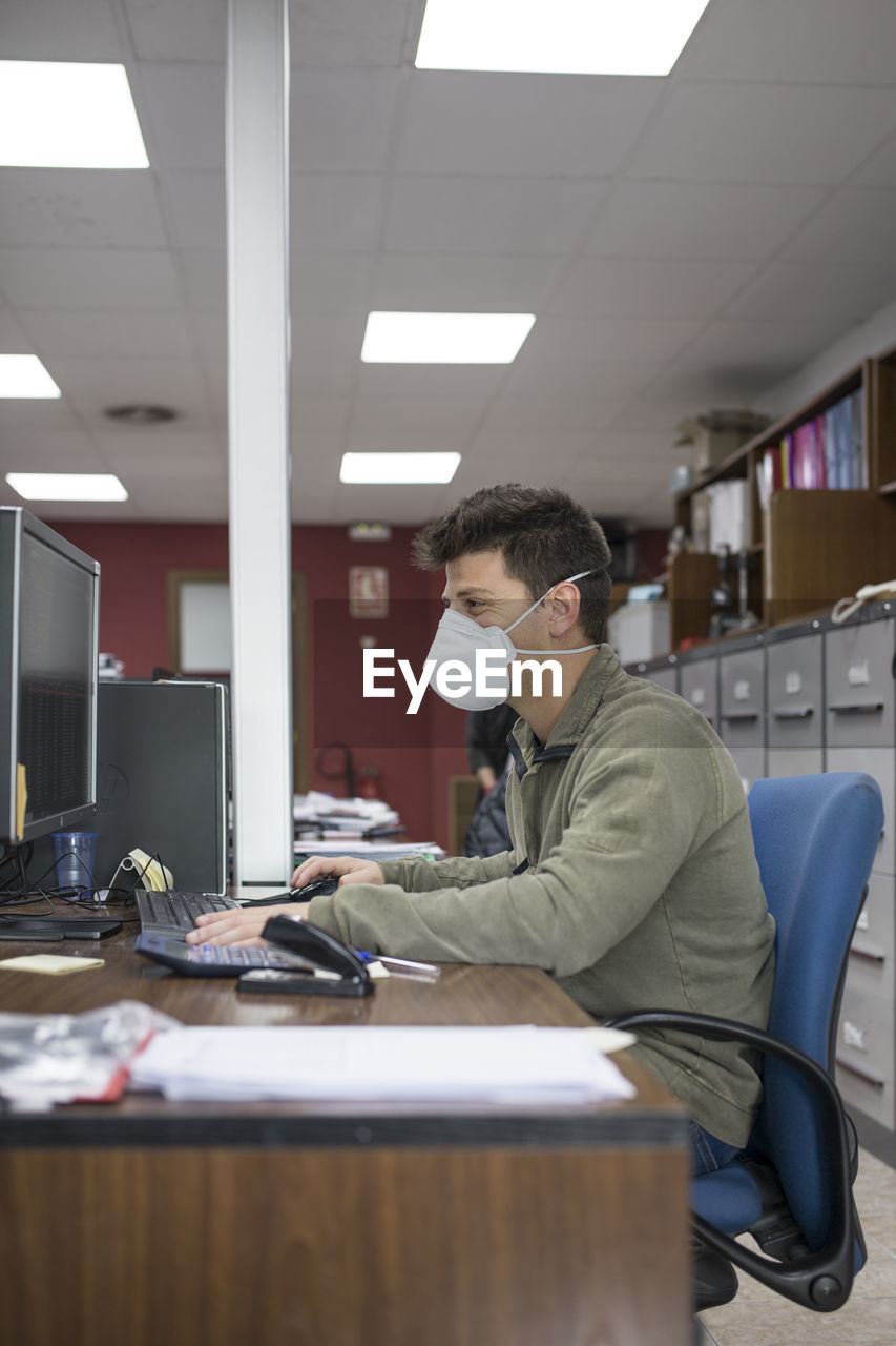 Man working on table in office