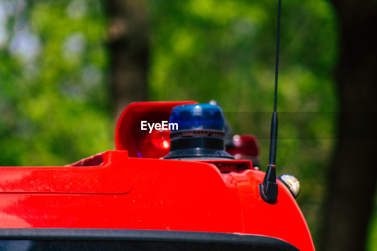 CLOSE-UP OF TOY CAR AGAINST RED BACKGROUND