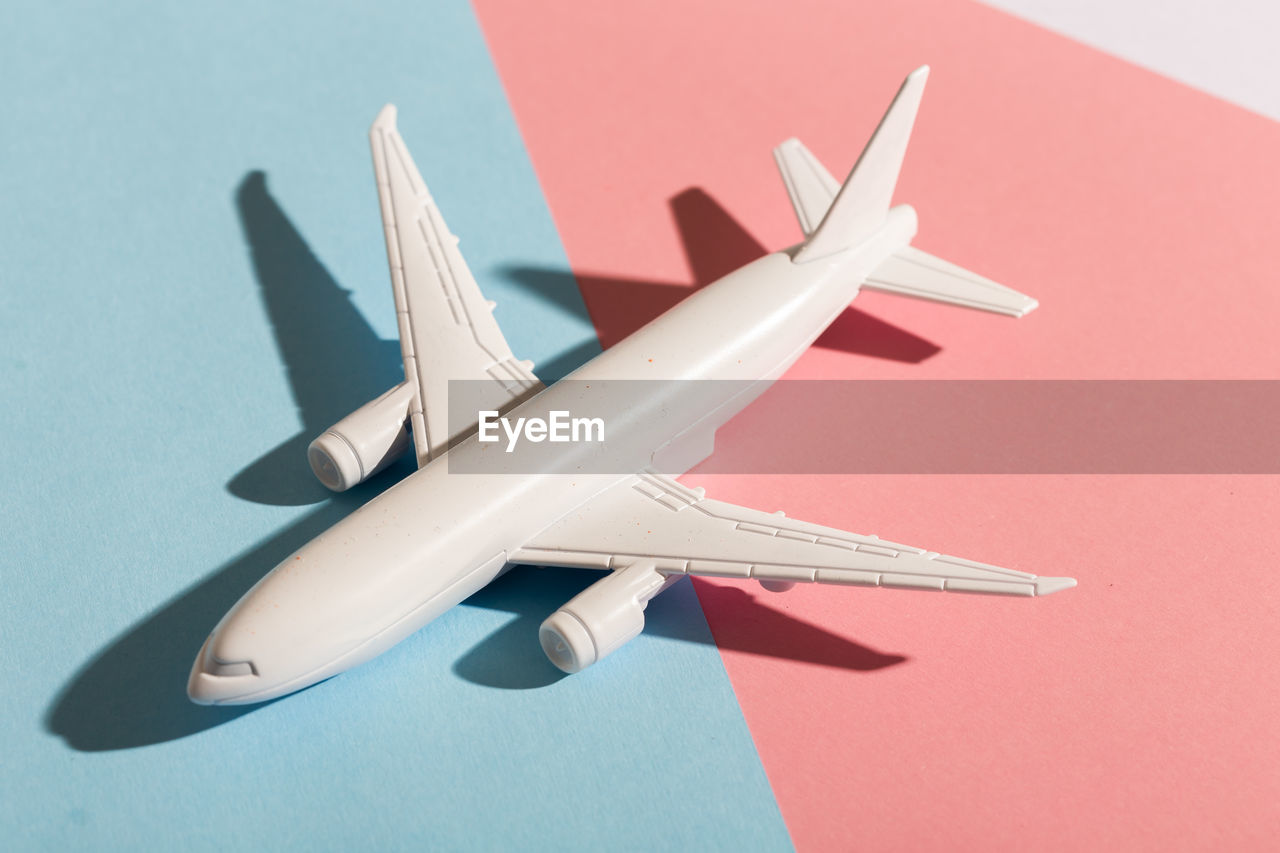 low angle view of airplane against blue background