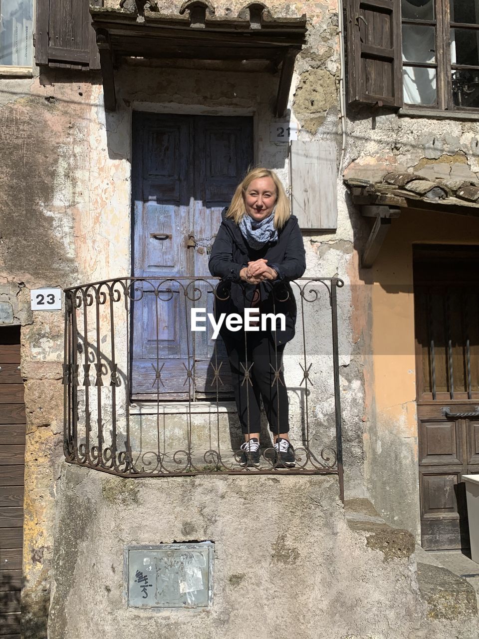 Portrait of woman standing by door